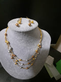 Golden jewelry set with beaded golden beads